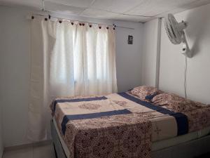 a bedroom with a bed and a window at Casa - chalet Cartagena in Cartagena de Indias