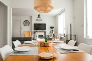 a dining room with a table with wine glasses at Le Terminus in Angers