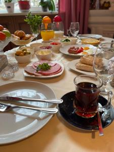 a table with plates of food and a cup of tea at My Home Guest House in Baku