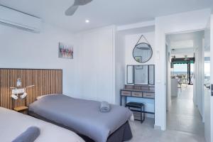 a bedroom with two beds and a desk with a mirror at Appartement PM 25 in Fuengirola