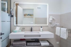 a bathroom with a white sink and a mirror at Appartement PM 25 in Fuengirola +14 photos