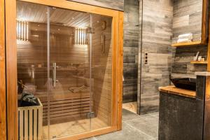 a shower with a glass door in a bathroom at Suite luxe l'Infini in Istres