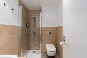 a bathroom with a shower and a toilet at Nena Apartments Berlin - Adlershof - "New Opening 2024" in Berlin