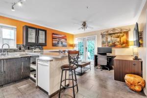 a kitchen with orange walls and a bar with a desk at Luxury Retreat in Vancouver in Vancouver