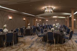 a banquet room with tables and chairs and a chandelier at Renaissance New Orleans Pere Marquette French Quarter Area Hotel in New Orleans