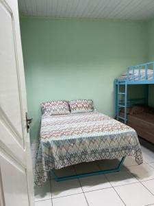 a bedroom with a bed and a bunk bed at Kitnet na cidade nova in Ananindeua