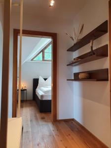 a bedroom with a bed and a window and a mirror at Gruberwirt Apartment mit Blick auf die Berge GW 7 in Innsbruck
