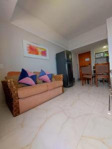 sala de estar con sofá y cocina en Flat Tropical Executive, en Manaus
