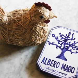 a sign for albero magico with a bird in a nest at Albero Mago in Florence