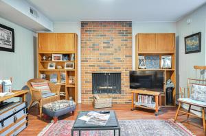 a living room with a fireplace and a tv at Cozy Portland Vacation Rental about 6 Mi to Downtown! in Portland