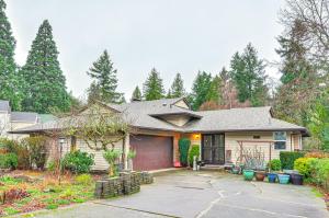 a house with a garage in a yard at Cozy Portland Vacation Rental about 6 Mi to Downtown! in Portland