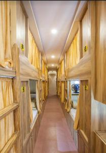a corridor of a train with beds in it at ABZA DELUXE DORMITORY in Mumbai