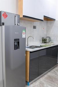 a kitchen with a refrigerator and a sink at The olive in Nairobi