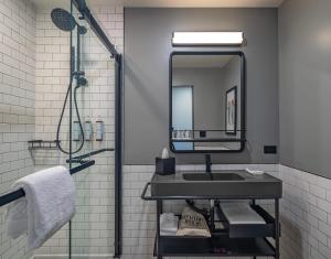 a bathroom with a sink and a mirror at Moxy Phoenix Downtown in Phoenix