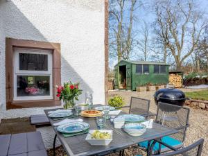 a table with plates of food on a patio at 3 Bed in Turriff 75489 in Turriff
