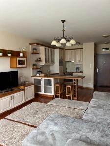 a kitchen with white cabinets and a kitchen island at Perfect Relax in Budapest