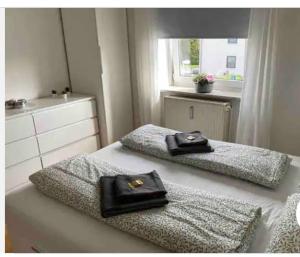 two beds in a room with two bags on them at Geschmackvoll eingerichtete Wohnung in Braunschweig in Braunschweig