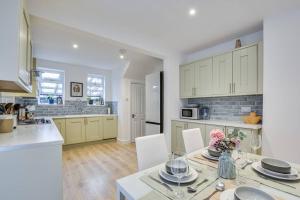 a kitchen with a table and chairs in a kitchen at Calming and Serene 2 BR Getaway in Worsley