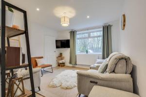 a living room with a couch and a mirror at Calming and Serene 2 BR Getaway in Worsley