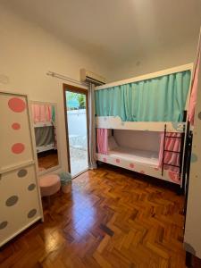 a room with two bunk beds and a wooden floor at Morada City Hostel in Sao Paulo