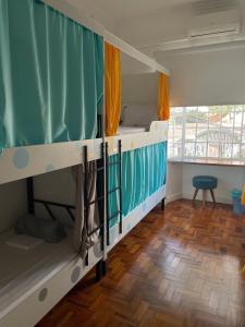 a dorm room with two bunk beds and a wooden floor at Morada City Hostel in Sao Paulo
