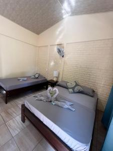 a bedroom with two beds and a fan at The Secret Eco Lodge in Tortuguero