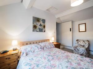 a bedroom with a bed and a chair at 2 Bed in Ashford in the Water PK932 in Great Longstone