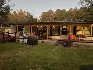 a house with a deck with orange chairs at Air b/b lodge in Windsor