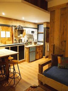 a large kitchen with a table and a kitchen with a tableablish at The Snug in Matlock