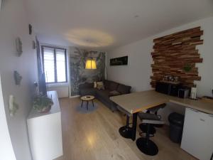 a living room with a table and a couch at Maison de ville in Bouguenais