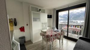 a room with a table with a laptop on it at La Méa in Barcelonnette