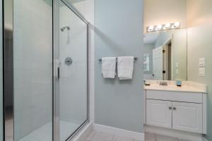 a bathroom with a shower and a sink at 1005 Crooked Oak Lane in Seabrook Island +36 photos