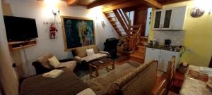 a living room with a couch and a tv at Apartment Dulovine in Kolašin