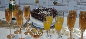 a table with champagne glasses and a birthday cake at Little Amanya Camp in Amboseli