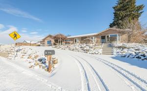 a herd of sheep grazing on a snow covered street at East Wenatchee Oasis 4BR, Pool, Hot Tub, Loop Trail in East Wenatchee