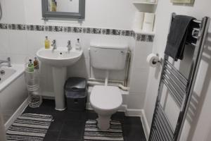 a small bathroom with a toilet and a sink at Dove's Place in historic Rochester with Parking in Strood +15 photos
