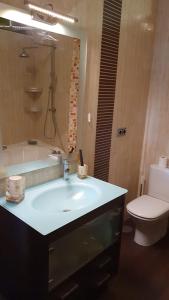 a bathroom with a sink and a tub and a toilet at Casa Pinares in Móstoles