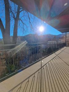 a view of the sun shining through a fence at Ferienapartment "Zur Linde" in Breitenstein