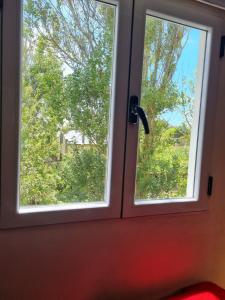 uma janela com vista para uma árvore em Cabañas Mi Lugar em Las Gaviotas