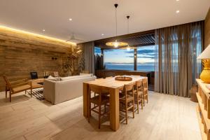 a dining room and living room with a table and chairs at 6 Guests - Amazing Views -Top Design in San José del Cabo