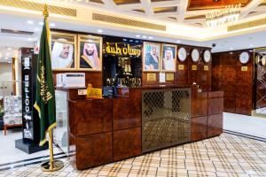 a bar in a store with posters on the wall at Nersyan Taiba Hotel Apartments in Medina