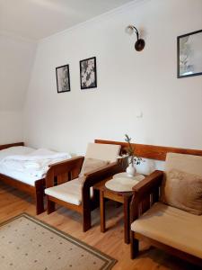 スロモフツェ・ビジネにあるWilla Przekopのベッド2台、テーブル、椅子が備わる客室です。
