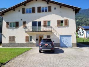 a car parked in front of a house at casa Battilana Li Curt - Poschiavo in Prada
