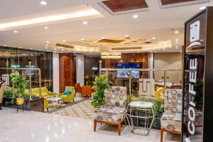 a lobby of a store with chairs and tables at Nersyan Taiba Hotel Apartments in Al Madinah