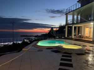 a swimming pool in front of a house at Belaya Udacha in Odesa