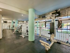 a gym with rows of treadmills and machines at Peaceful Retreat, Pools, Gym, Parks in Cape Town