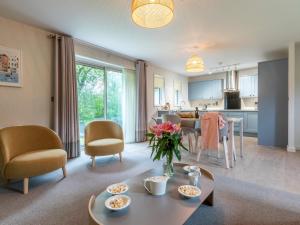 a living room with a table and a kitchen at 2 Bed in St. Mellion 87714 in St. Mellion