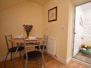 a dining room with a table and chairs and a window at 2 Bed in Knighton 62209 in Knighton