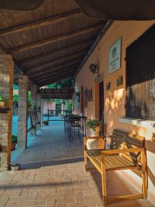 a wooden bench sitting on the side of a building at Nuovo Agriturismo Villa Enrichetta in Bettola