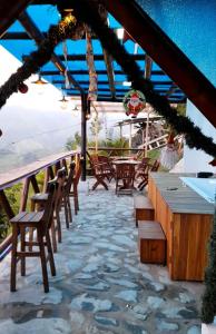 a patio with tables and chairs and a view of the ocean at Cabin in the Mountains - Chalet in Ibagué